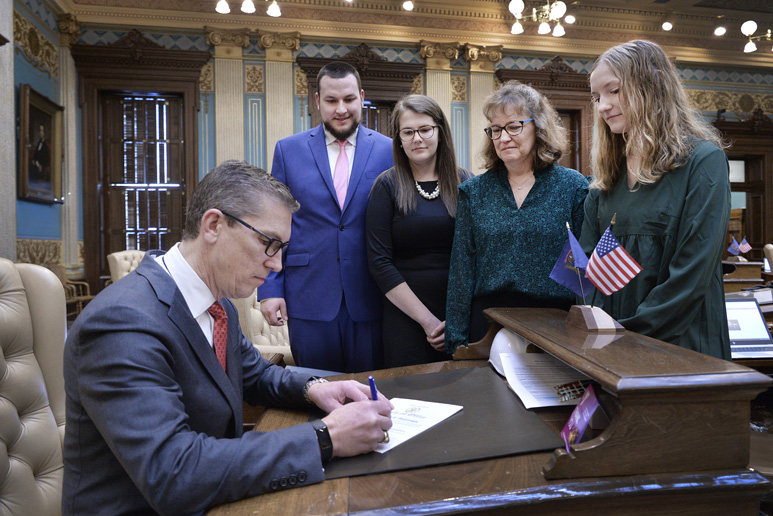 Mark Huizenga bipartisan leader legislation signing with family